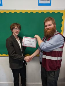 UK Mathematics Trust Oympian Cas K receiving his Certificate of Merit from Mr Rasbash