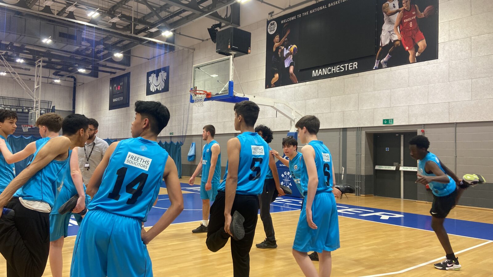 Year 9 boys warm up at the National Basketball Arena in Manchester ahead of their game against Sale Grammar in the National Schools Cup.